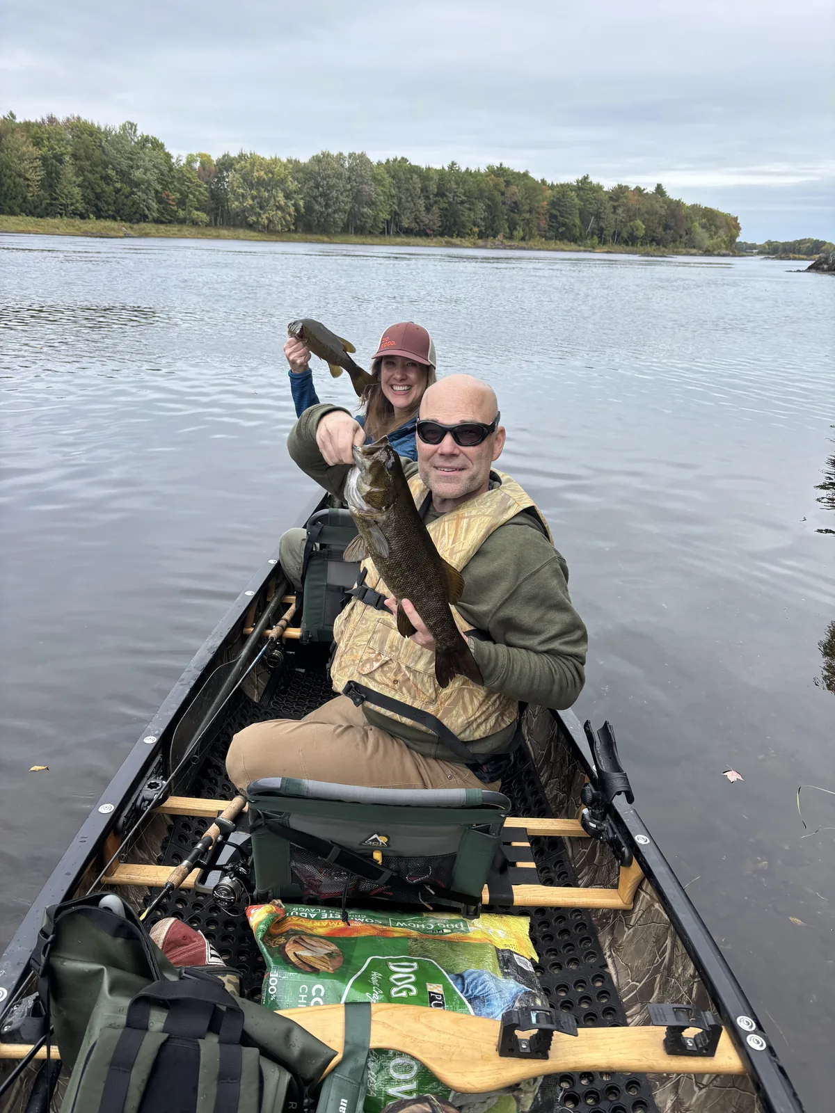 Clients fishing from a canoe during a guided trip on a Maine lake
