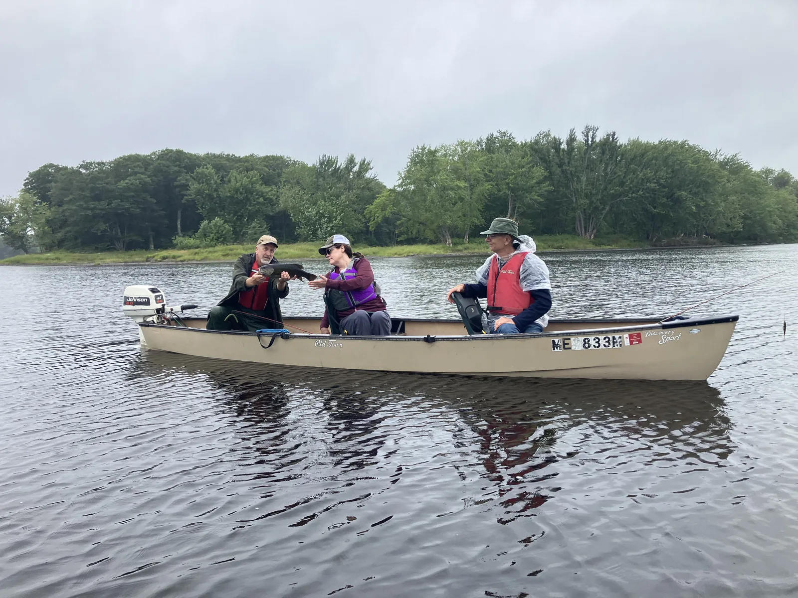 Group of anglers in a boat during a guided Maine fishing trip