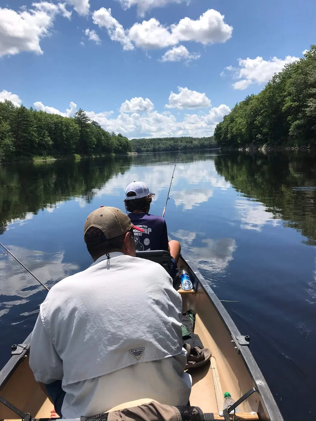 Anglers in a canoe on a calm Maine river