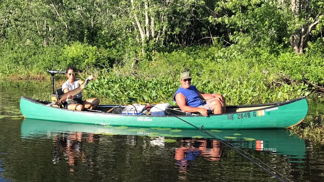 Clients in a canoe during a guided Maine river trip