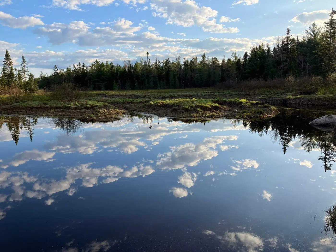 Maine river scene with clouds reflected in the water