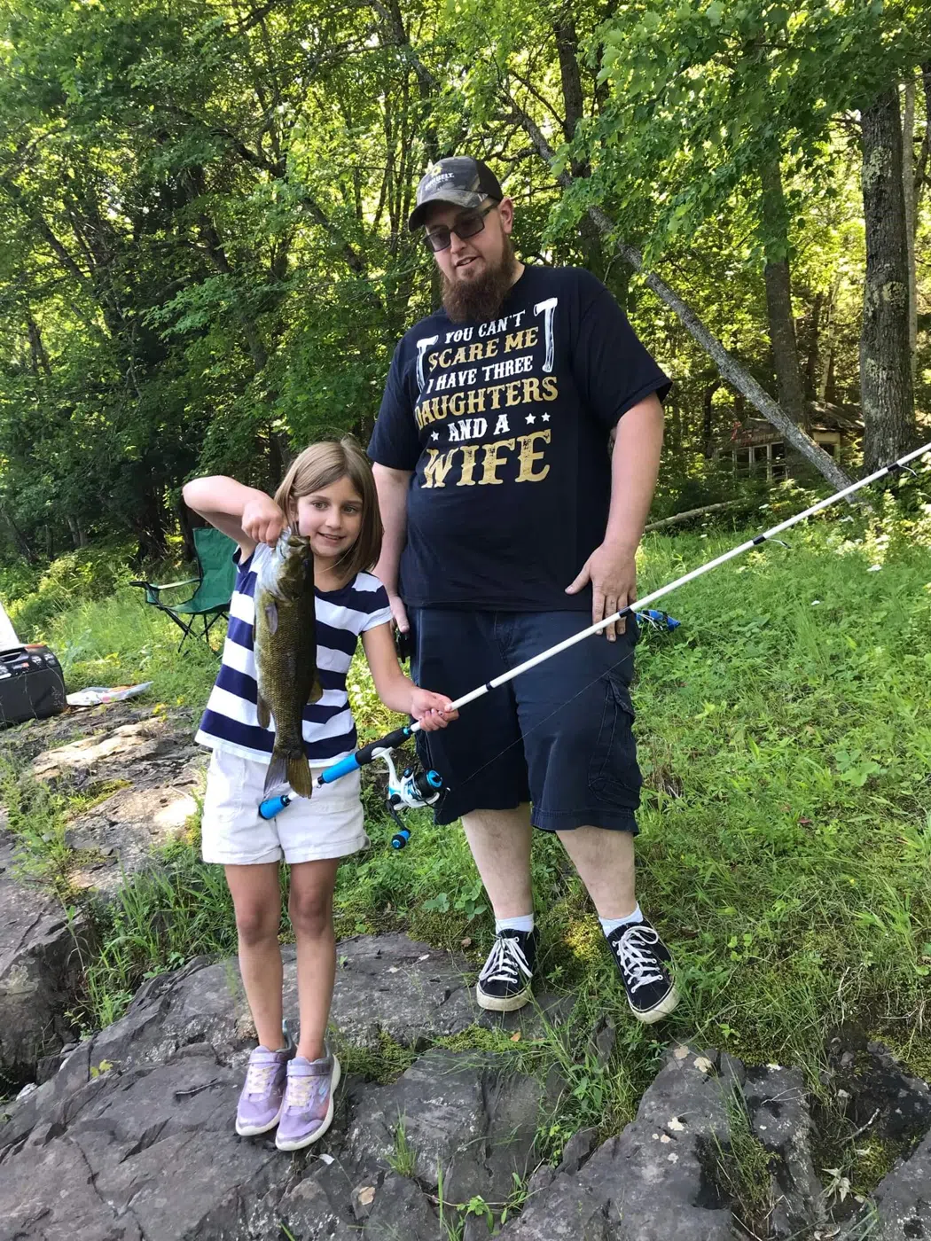 Young angler holding a fish during a guided Maine fishing trip