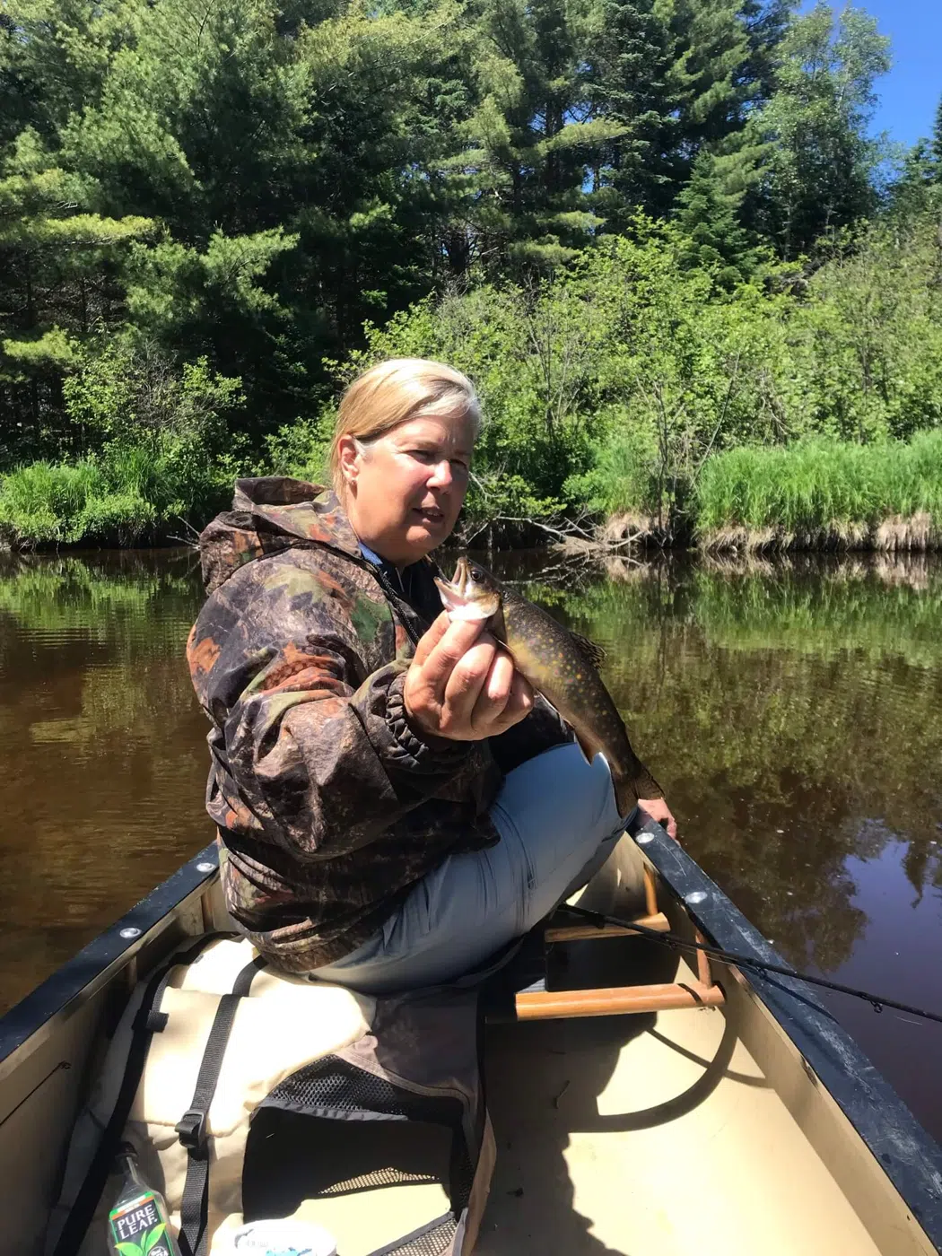 Client fishing from a canoe on a Maine river