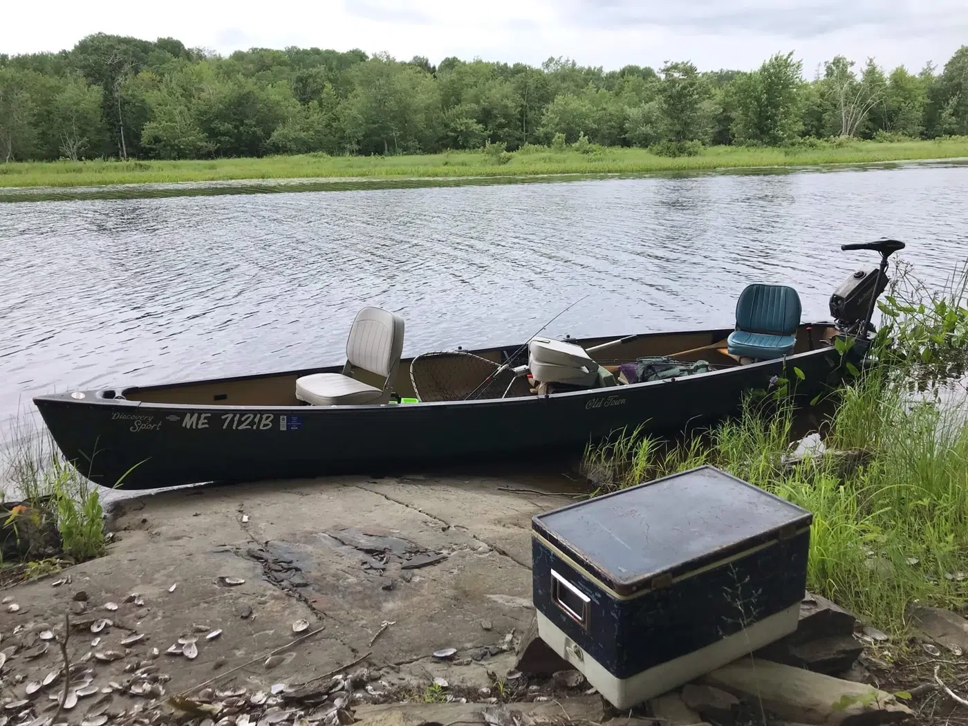 Canoe pulled up along a Maine river shore