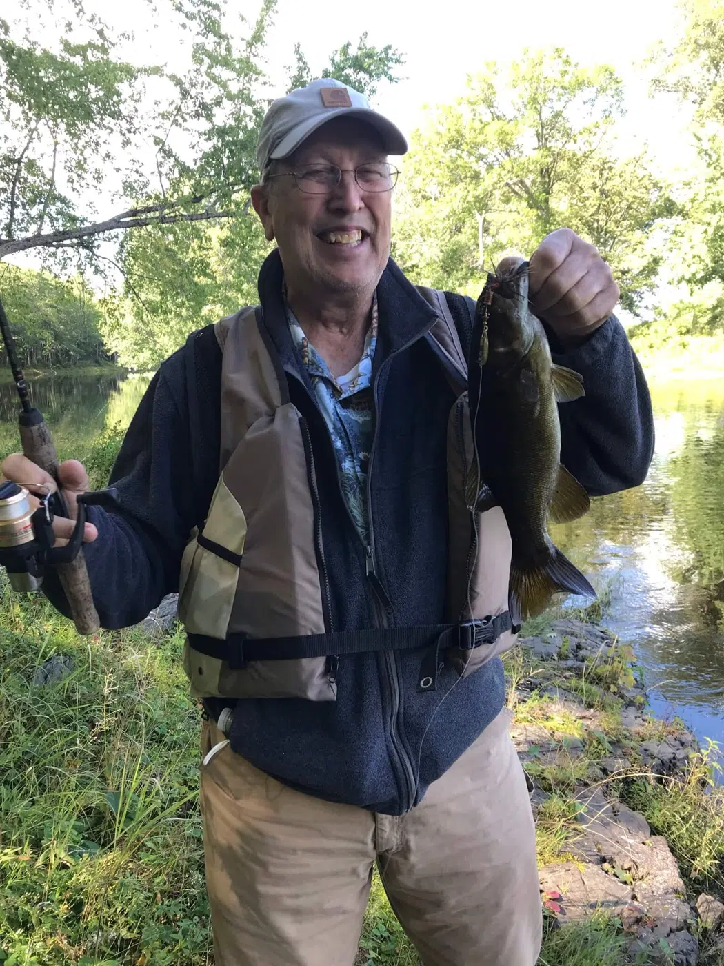 Client holding two fish during a guided Maine fishing trip
