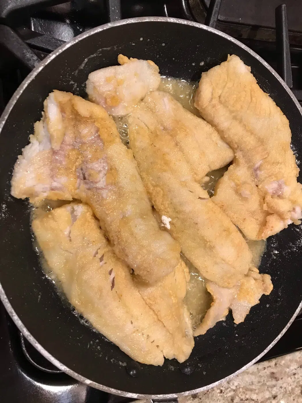 Fish cooking in a pan during a guided trip lunch