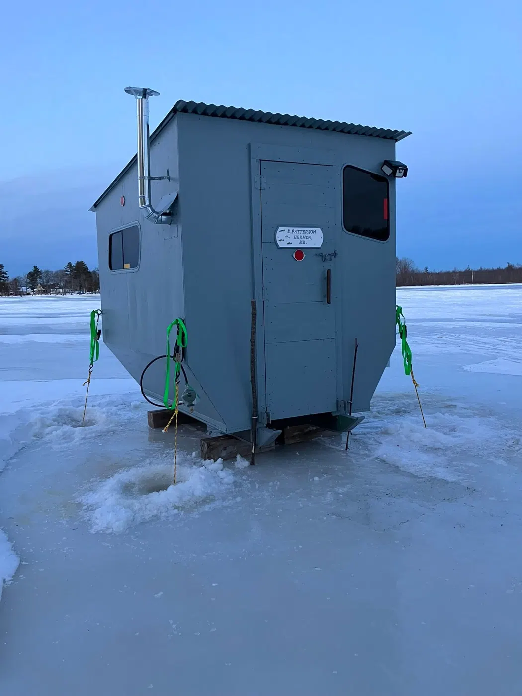 Ice fishing shack on a frozen Maine lake