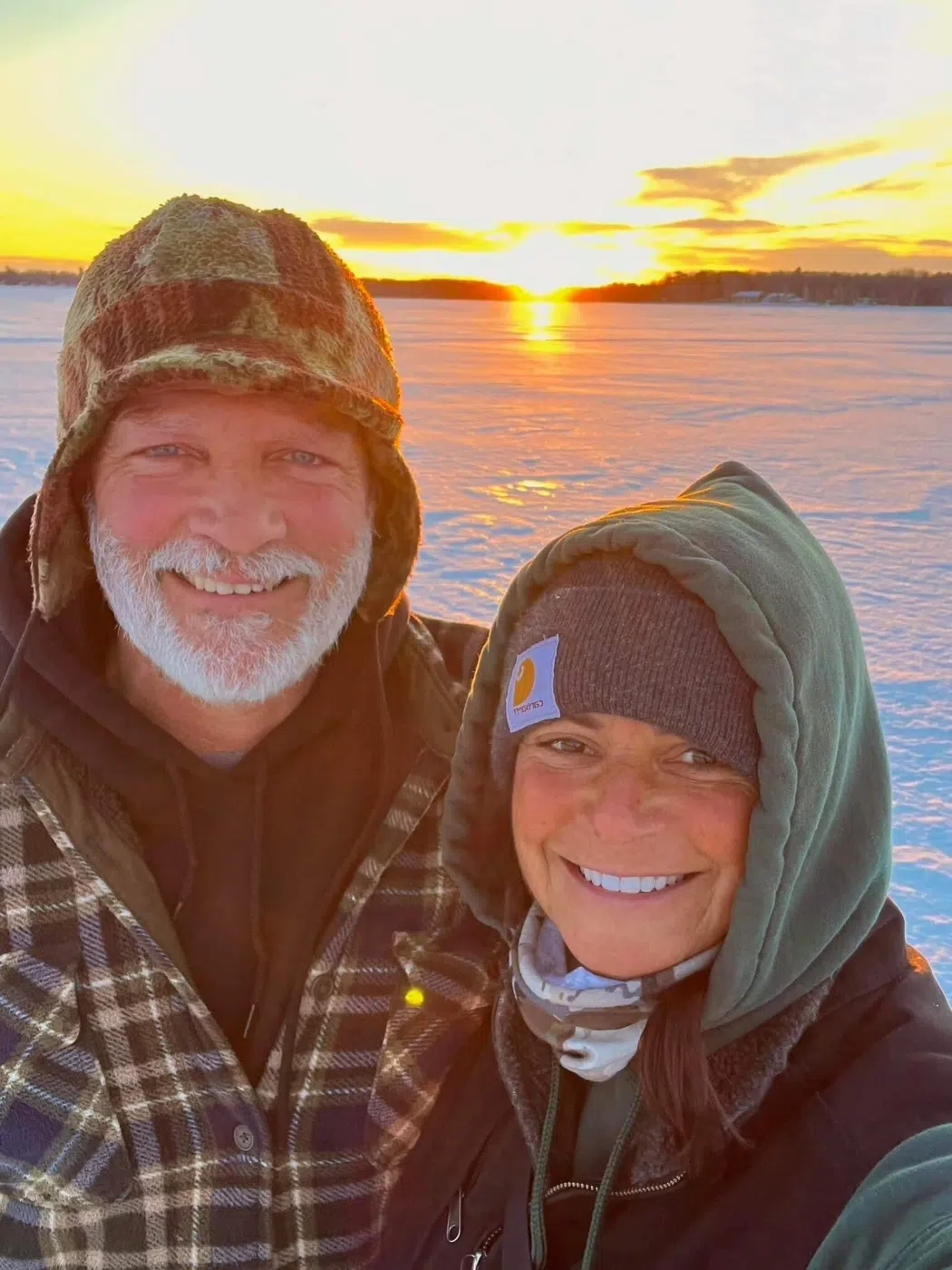 Guides Jim and Shelley Fahey smiling at sunset