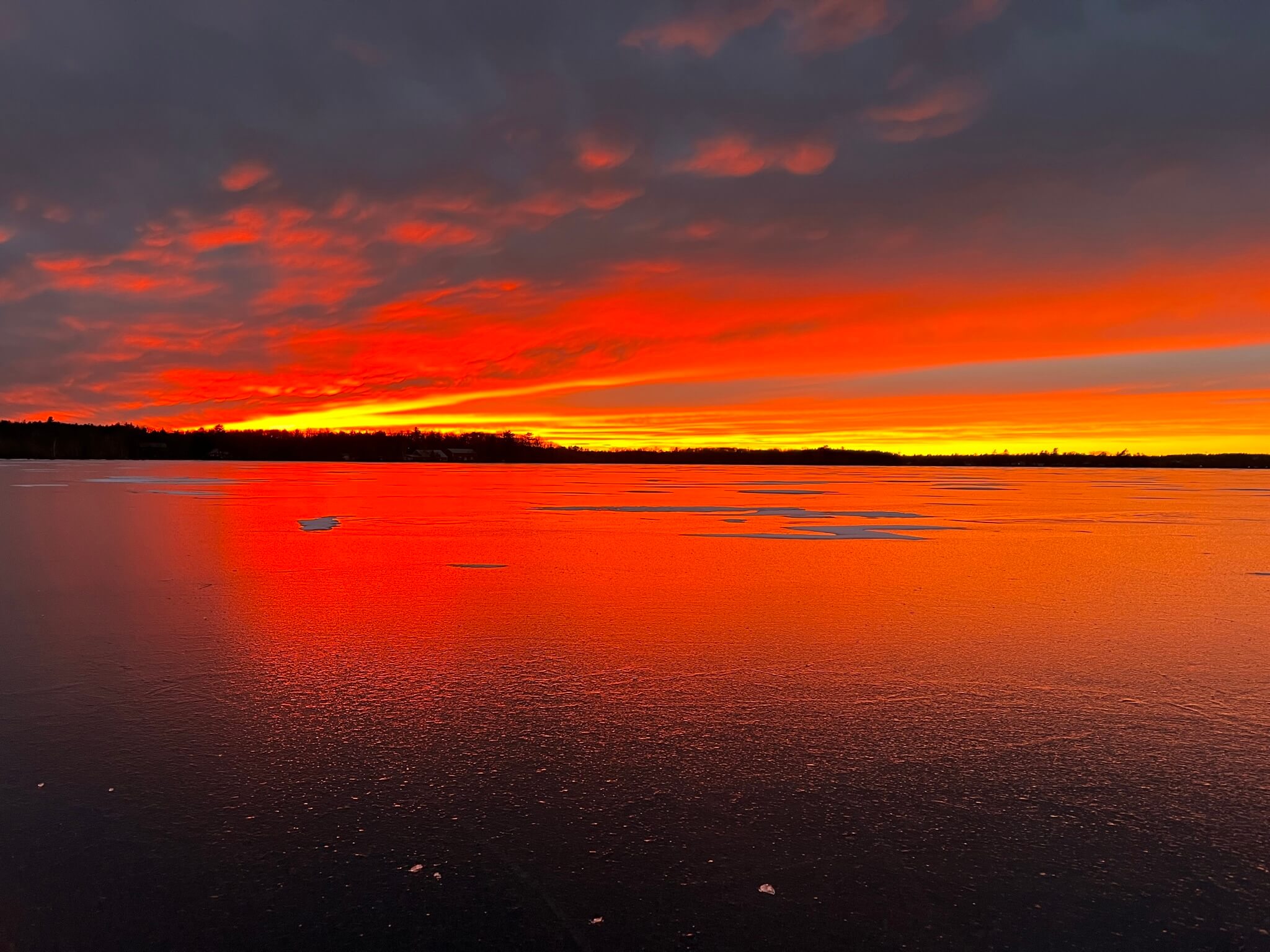 Sunset over frozen lake
